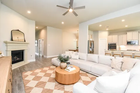 a living room with furniture fireplace and window