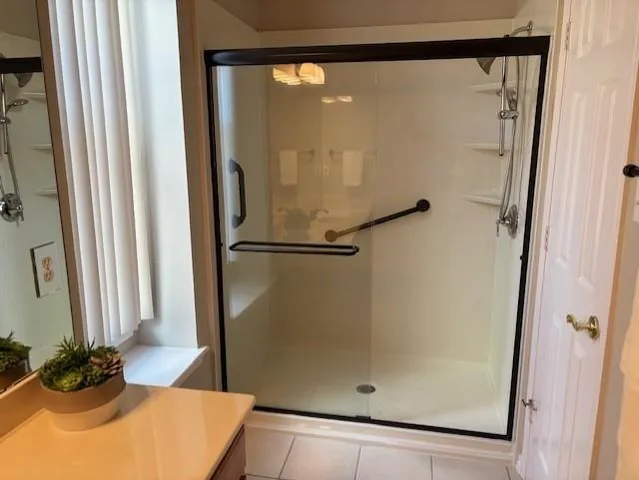 a bathroom with a tub sink and mirror