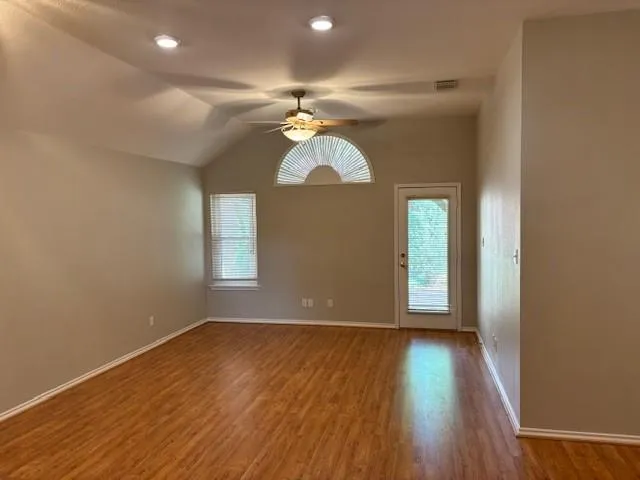 wooden floor in an empty room with a window