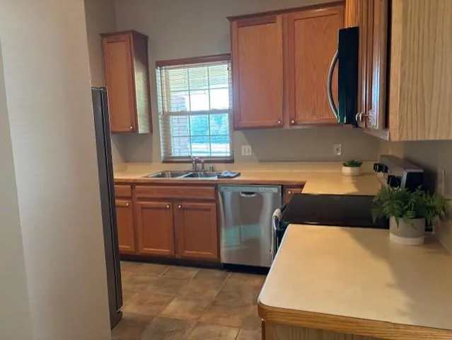 a kitchen with sink a window and cabinets