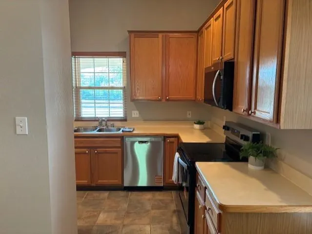 a kitchen with a refrigerator and a sink
