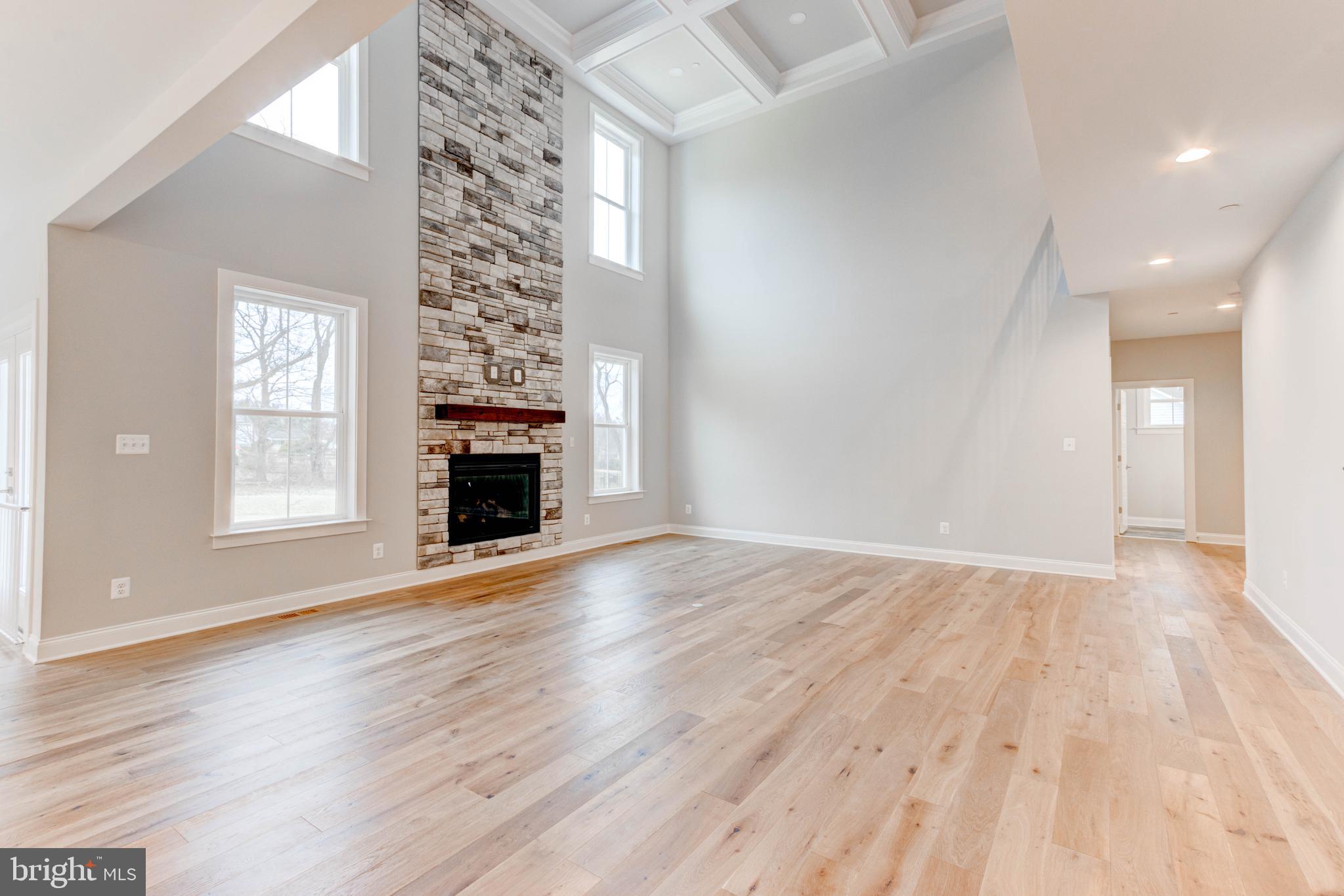 3114 Mt Zion Road Upperco, MD 21155 - Photo 15 of 61 an empty room with wooden floor fireplace and windows