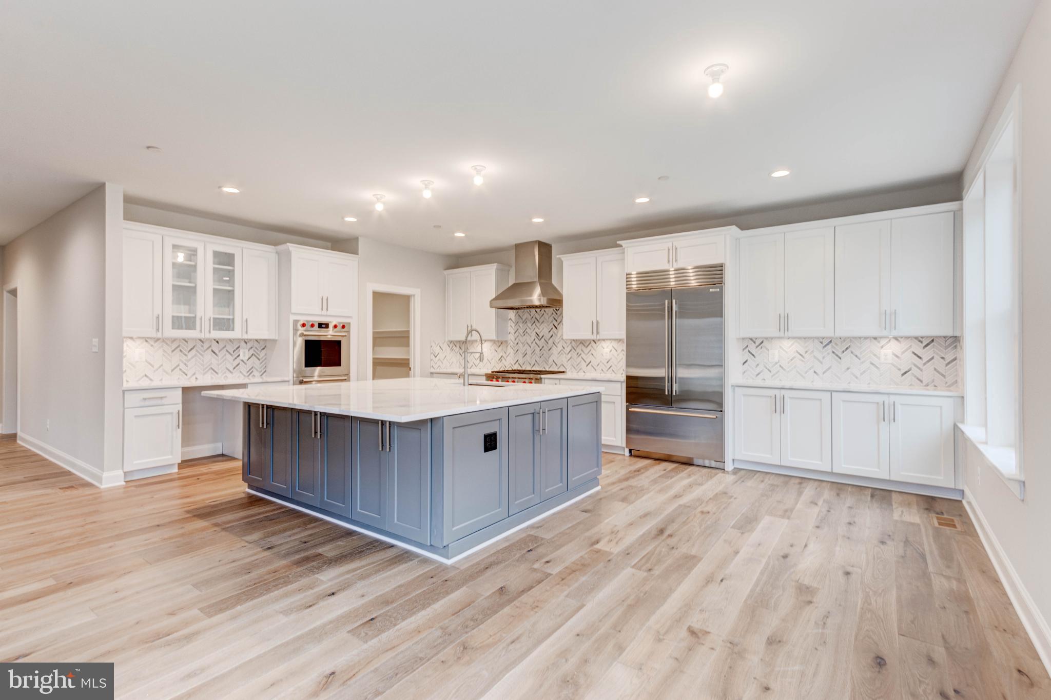 3114 Mt Zion Road Upperco, MD 21155 - Photo 21 of 61 a large kitchen with a center island wooden floor stainless steel appliances and cabinets