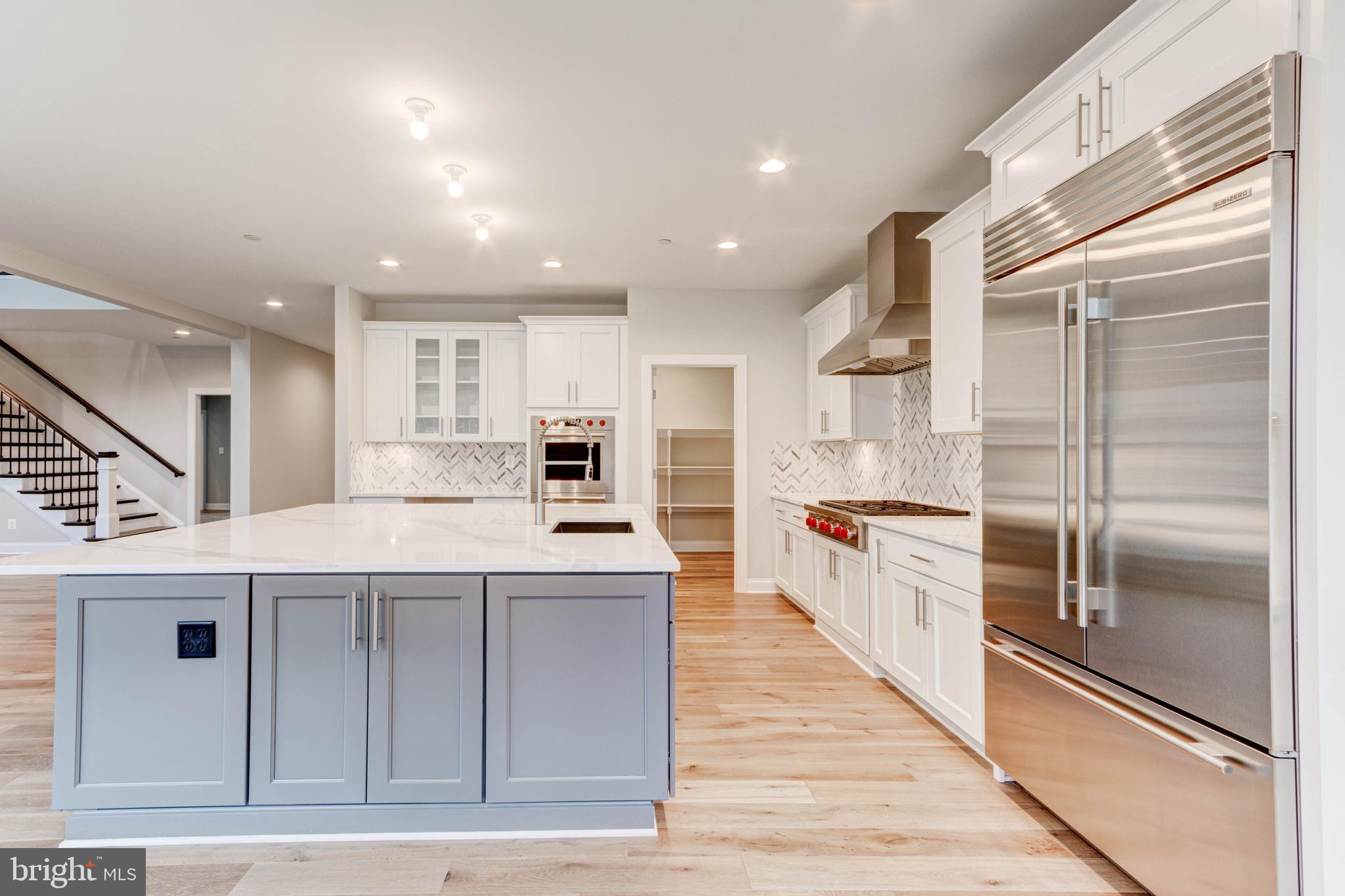 3114 Mt Zion Road Upperco, MD 21155 - Photo 22 of 61 a large kitchen with stainless steel appliances kitchen island a large counter top and a refrigerator