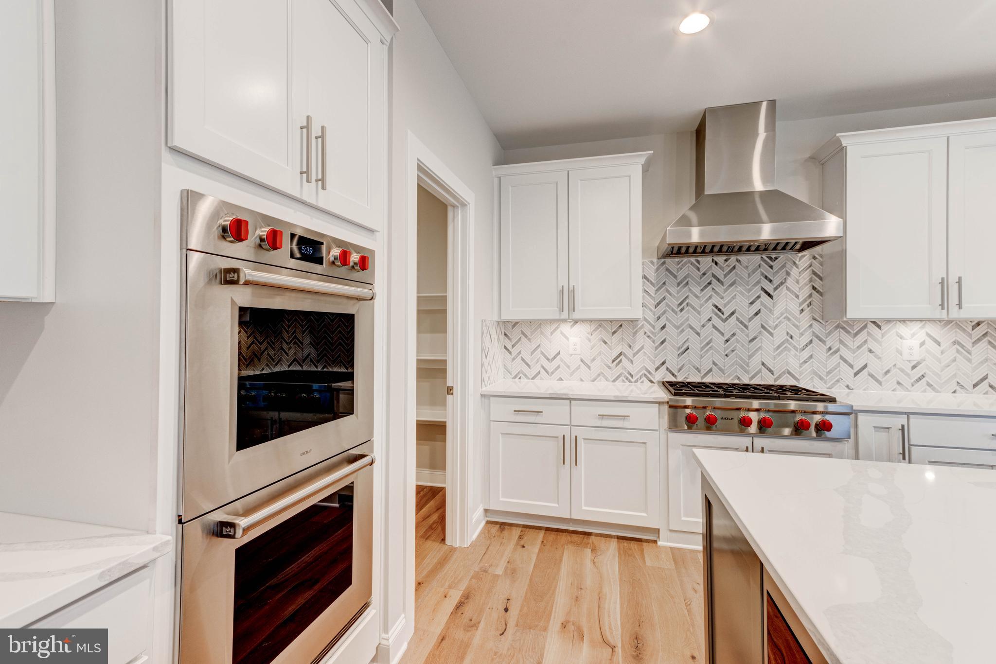 3114 Mt Zion Road Upperco, MD 21155 - Photo 27 of 61 a kitchen with stainless steel appliances a stove and white cabinets