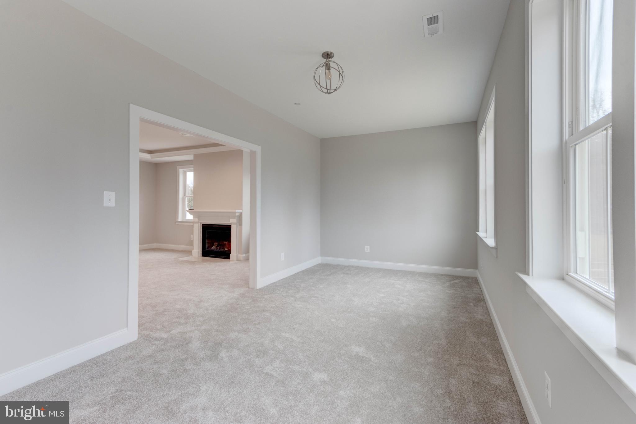 3114 Mt Zion Road Upperco, MD 21155 - Photo 49 of 61 an empty room with windows and fireplace