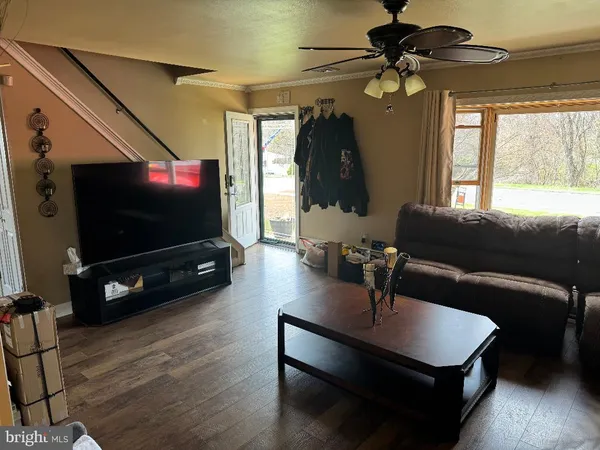 a living room with furniture and a flat screen tv