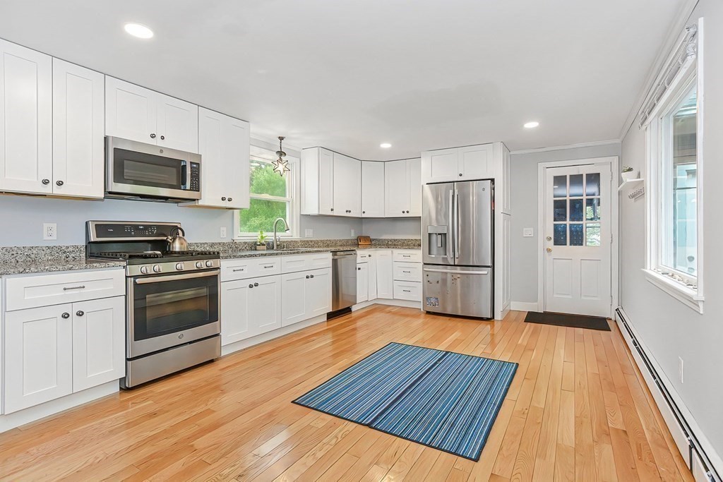 79 Emerson Way Barnstable, MA 02632 - Photo 13 of 29 a kitchen with wooden floors stainless steel appliances and window