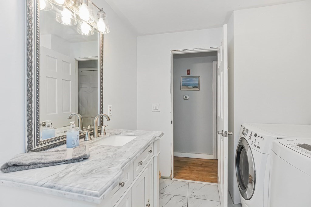 79 Emerson Way Barnstable, MA 02632 - Photo 14 of 29 a bathroom with a sink a washer and dryer
