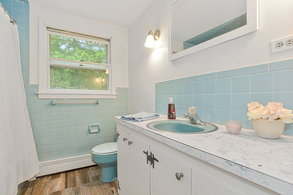 79 Emerson Way Barnstable, MA 02632 - Photo 19 of 29 a bathroom with a sink a toilet and a mirror