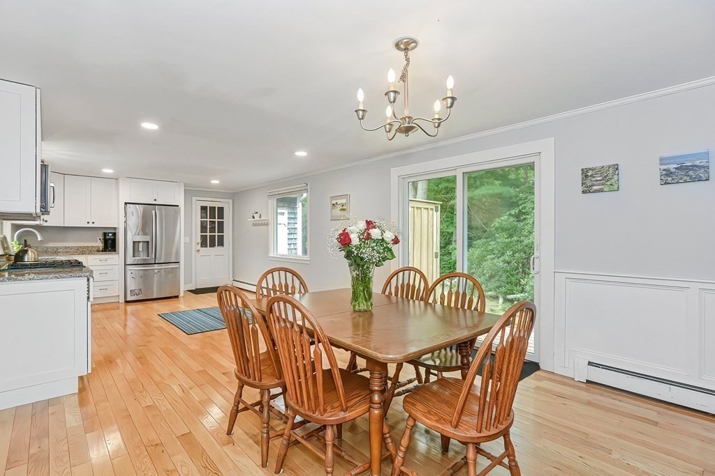 79 Emerson Way Barnstable, MA 02632 - Photo 8 of 29 a dining room with furniture a chandelier and wooden floor