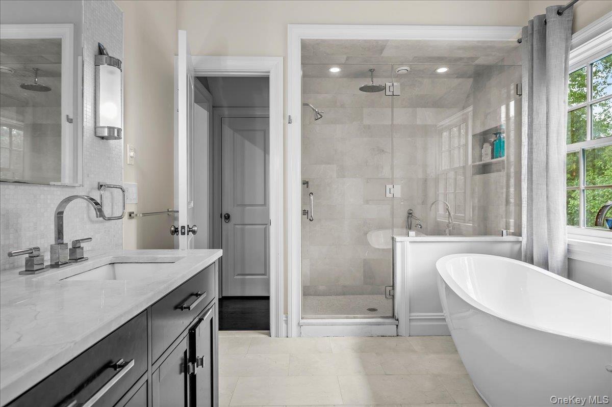 7 Harcourt Road Scarsdale, NY 10583 - Photo 18 of 34 a bathroom with a tub sink shower and mirror
