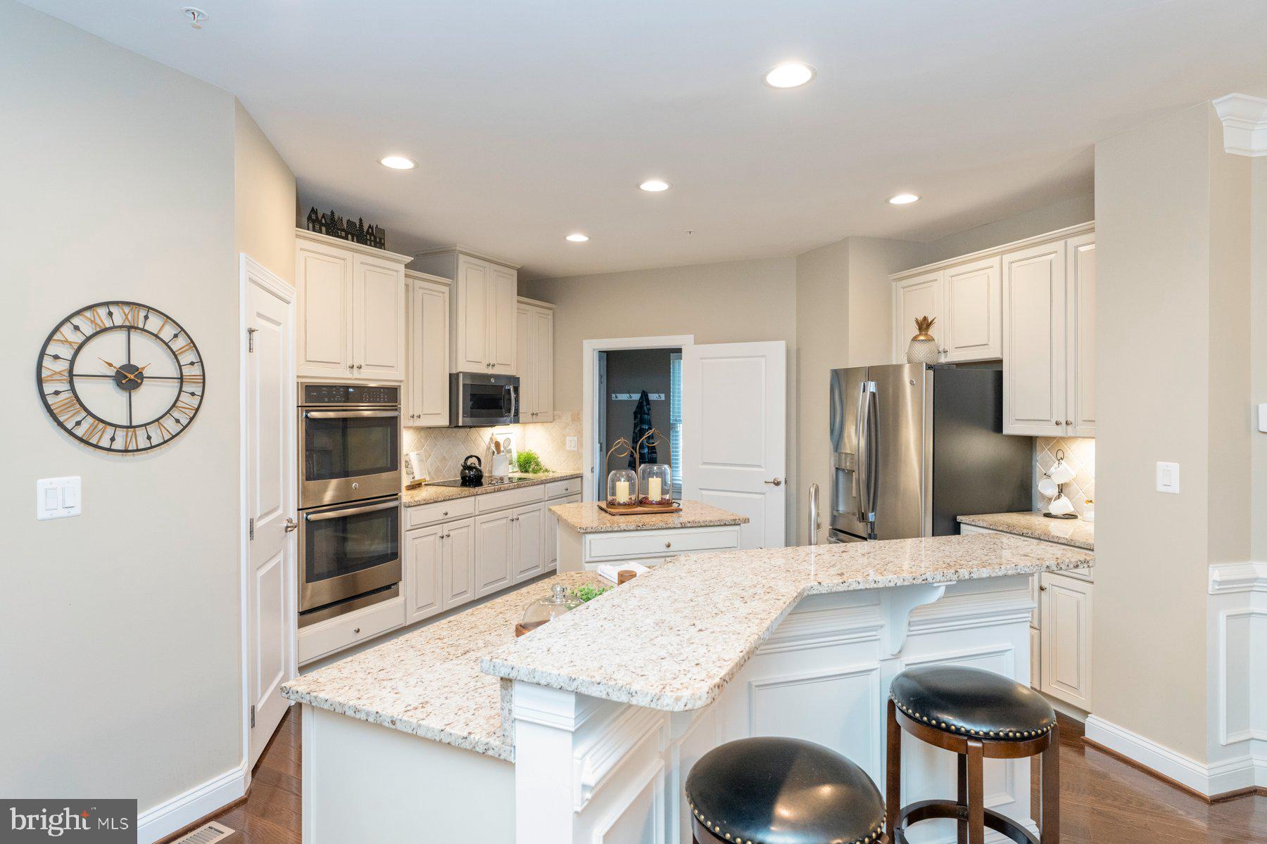 6931 Summit Circle Baltimore, MD 21239 - Photo 12 of 39 a kitchen with stainless steel appliances granite countertop a sink a stove a refrigerator with a dining table and chairs