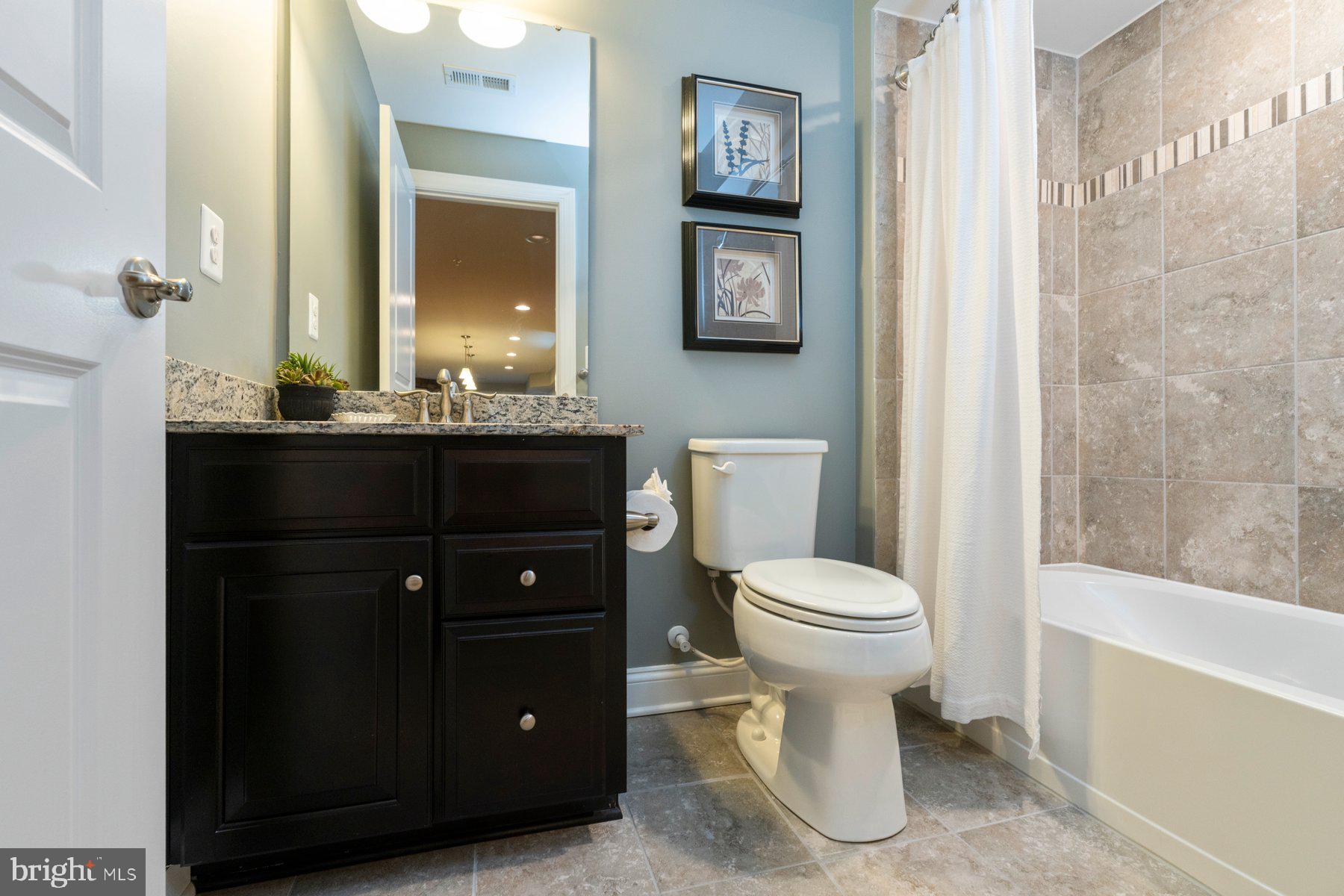 6931 Summit Circle Baltimore, MD 21239 - Photo 13 of 39 a bathroom with a toilet a sink and mirror