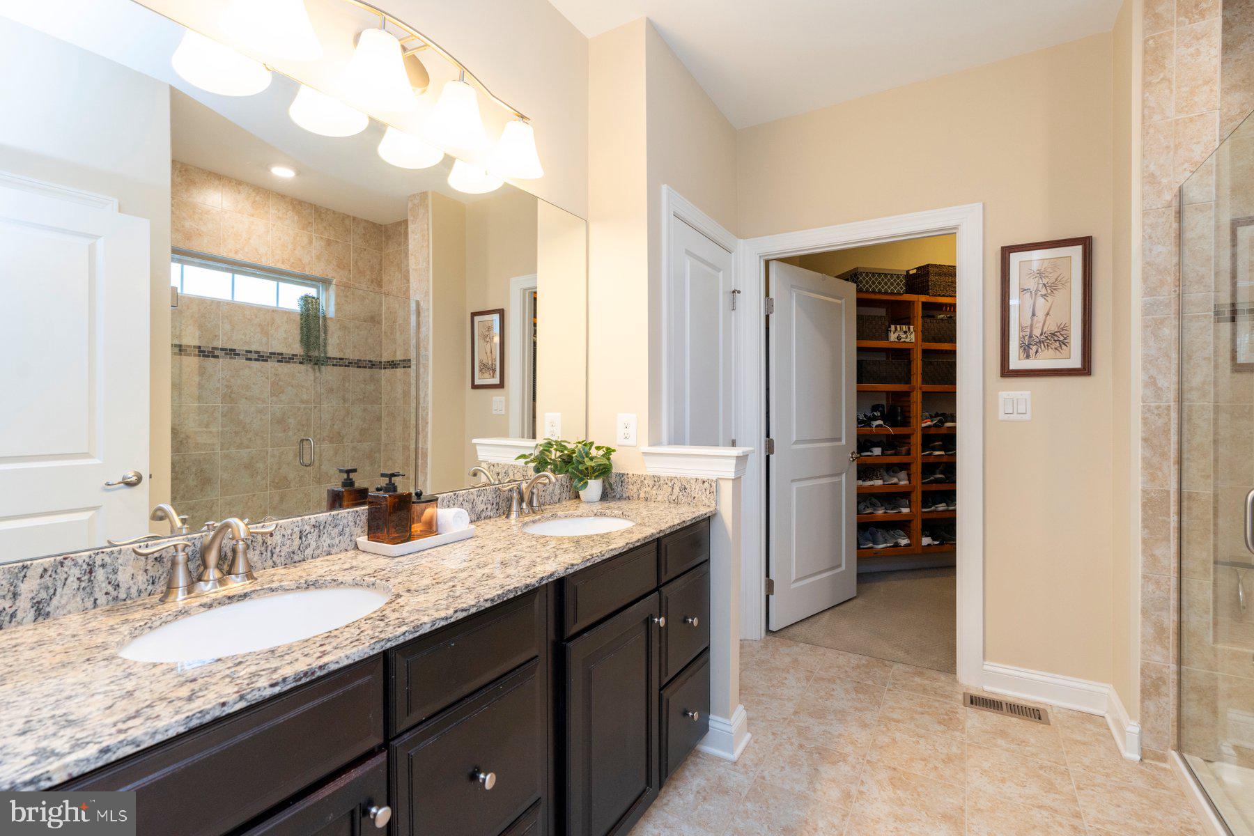 6931 Summit Circle Baltimore, MD 21239 - Photo 25 of 39 a bathroom with a granite countertop sink and a mirror