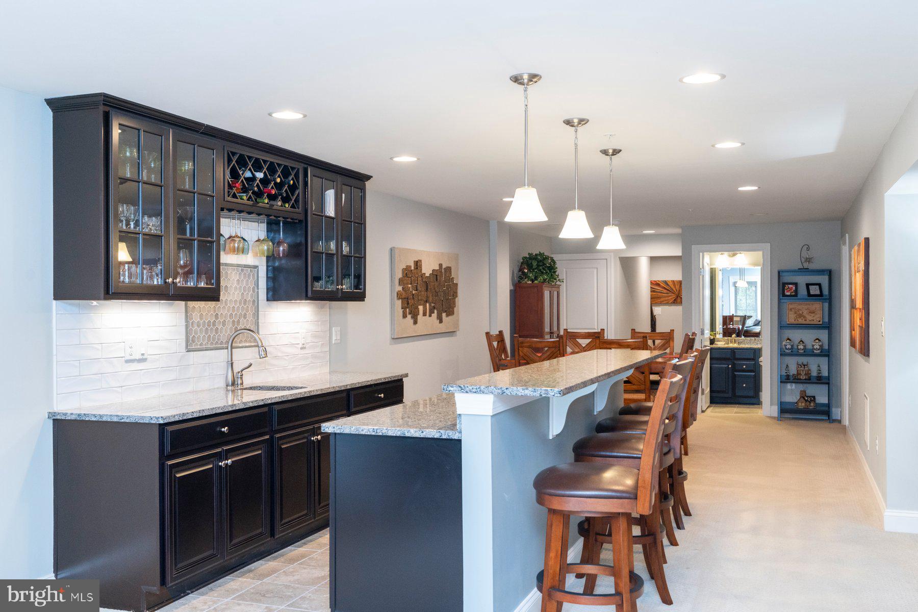 6931 Summit Circle Baltimore, MD 21239 - Photo 28 of 39 a kitchen with stainless steel appliances kitchen island granite countertop a stove a sink a refrigerator and chairs