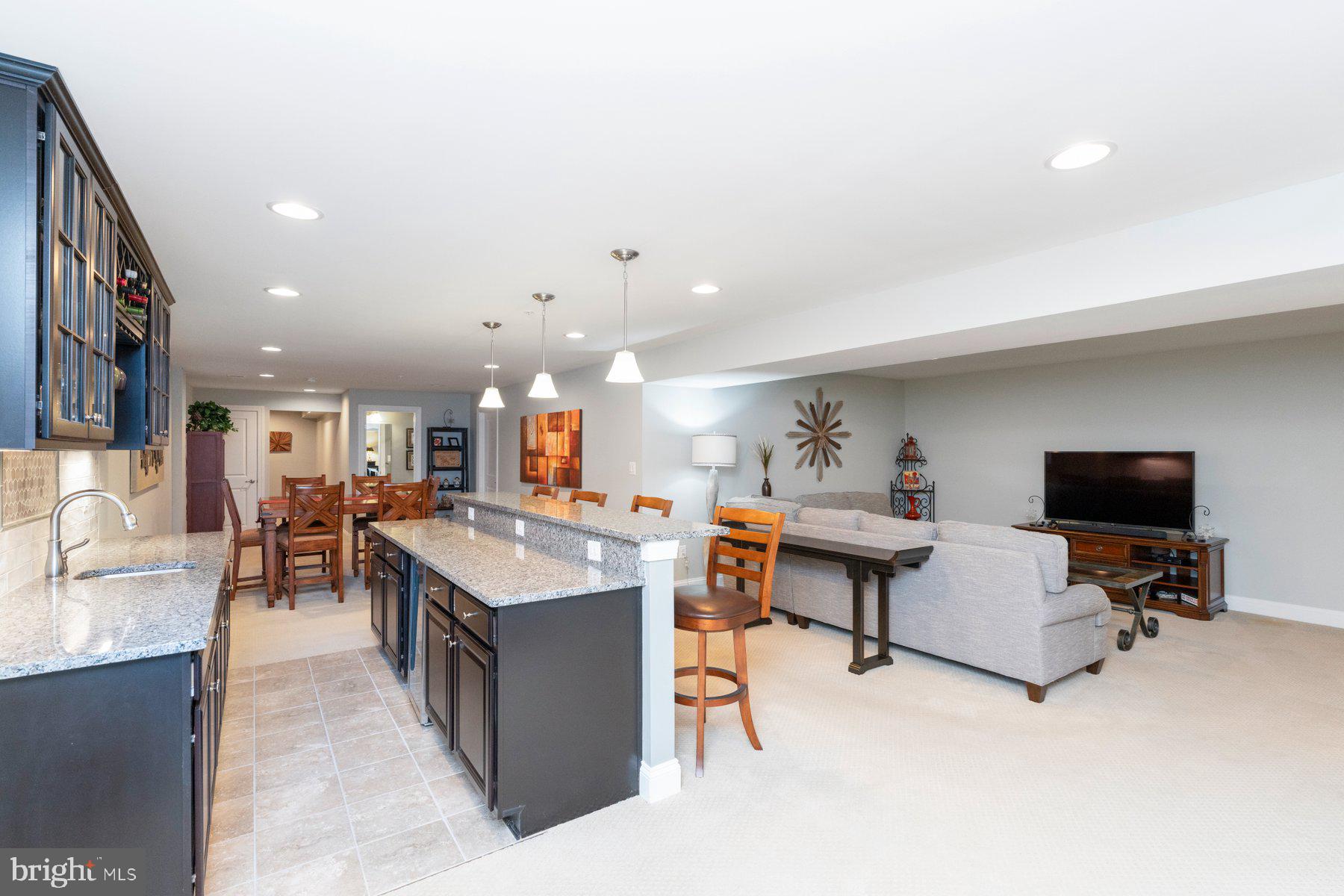 6931 Summit Circle Baltimore, MD 21239 - Photo 29 of 39 a living room with furniture a flat screen tv and kitchen view