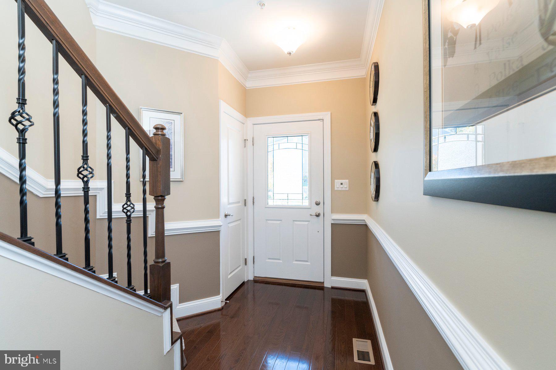 6931 Summit Circle Baltimore, MD 21239 - Photo 4 of 39 a view of an entryway with wooden floor and staircase