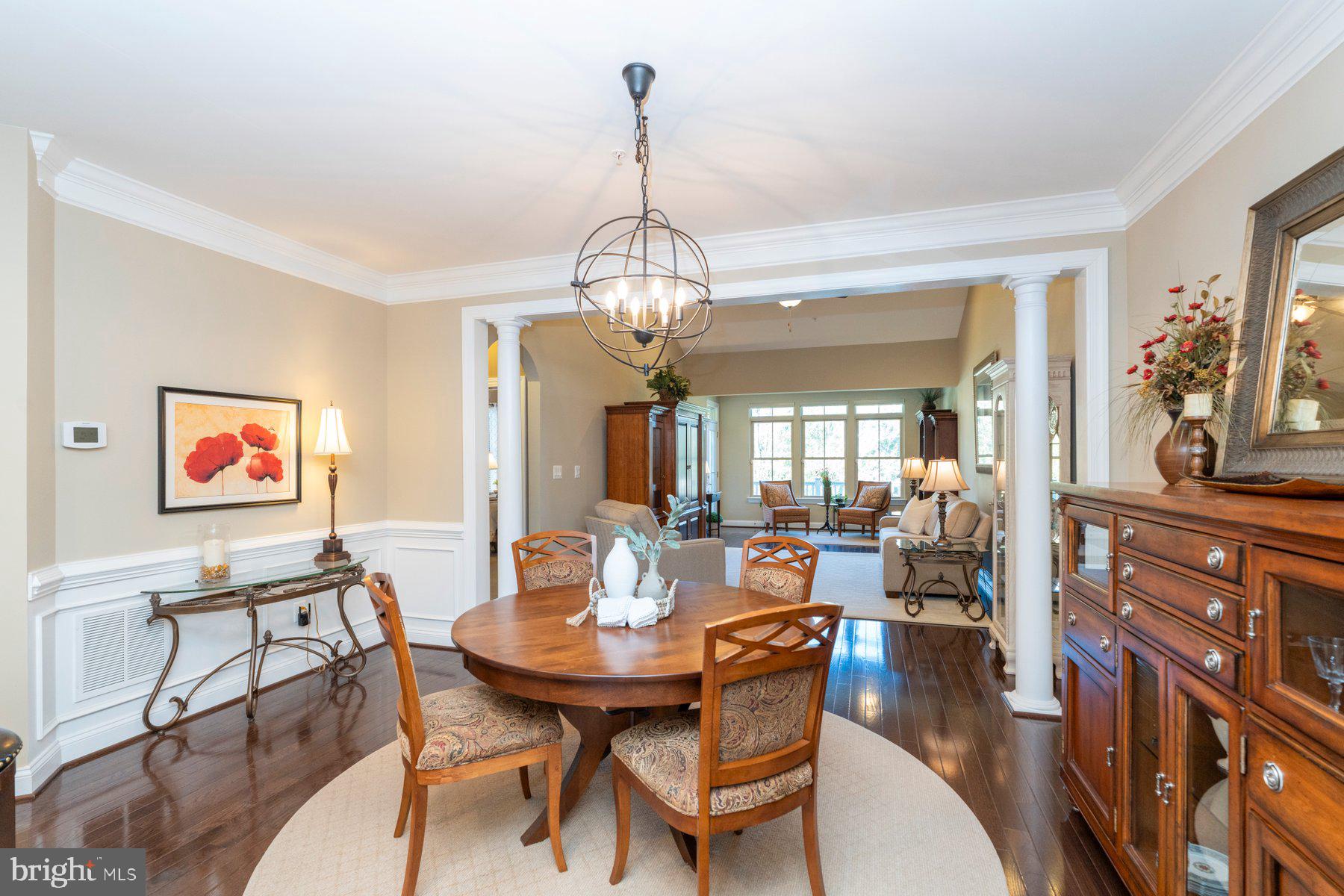 6931 Summit Circle Baltimore, MD 21239 - Photo 9 of 39 a view of a dining room with furniture wooden floor and a chandelier
