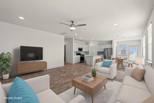 a spacious bedroom with a bed and a potted plant