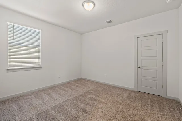 a bedroom with a bed and a potted plant