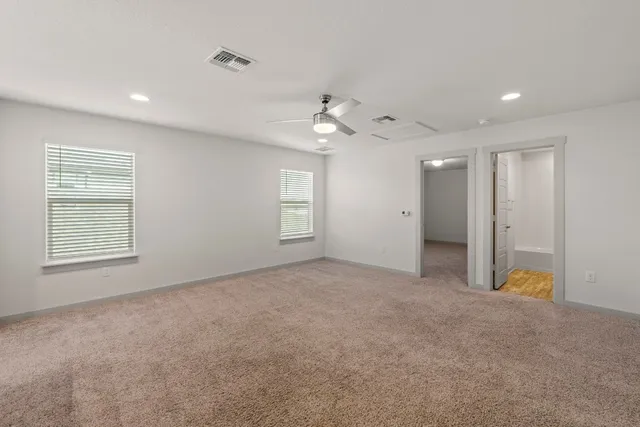 a view of a house with backyard and wooden fence