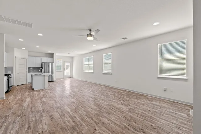 a kitchen with stainless steel appliances a refrigerator sink and stove