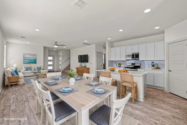 a kitchen with granite countertop white cabinets sink and stainless steel appliances