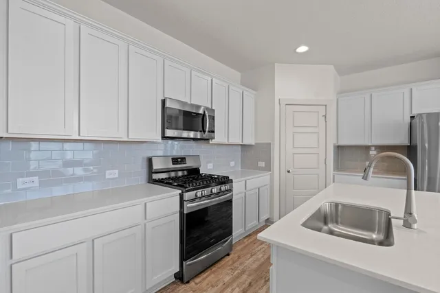 a living room with furniture kitchen view and a flat screen tv