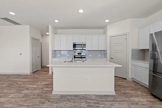 a view of a kitchen with a sink and a stove top oven
