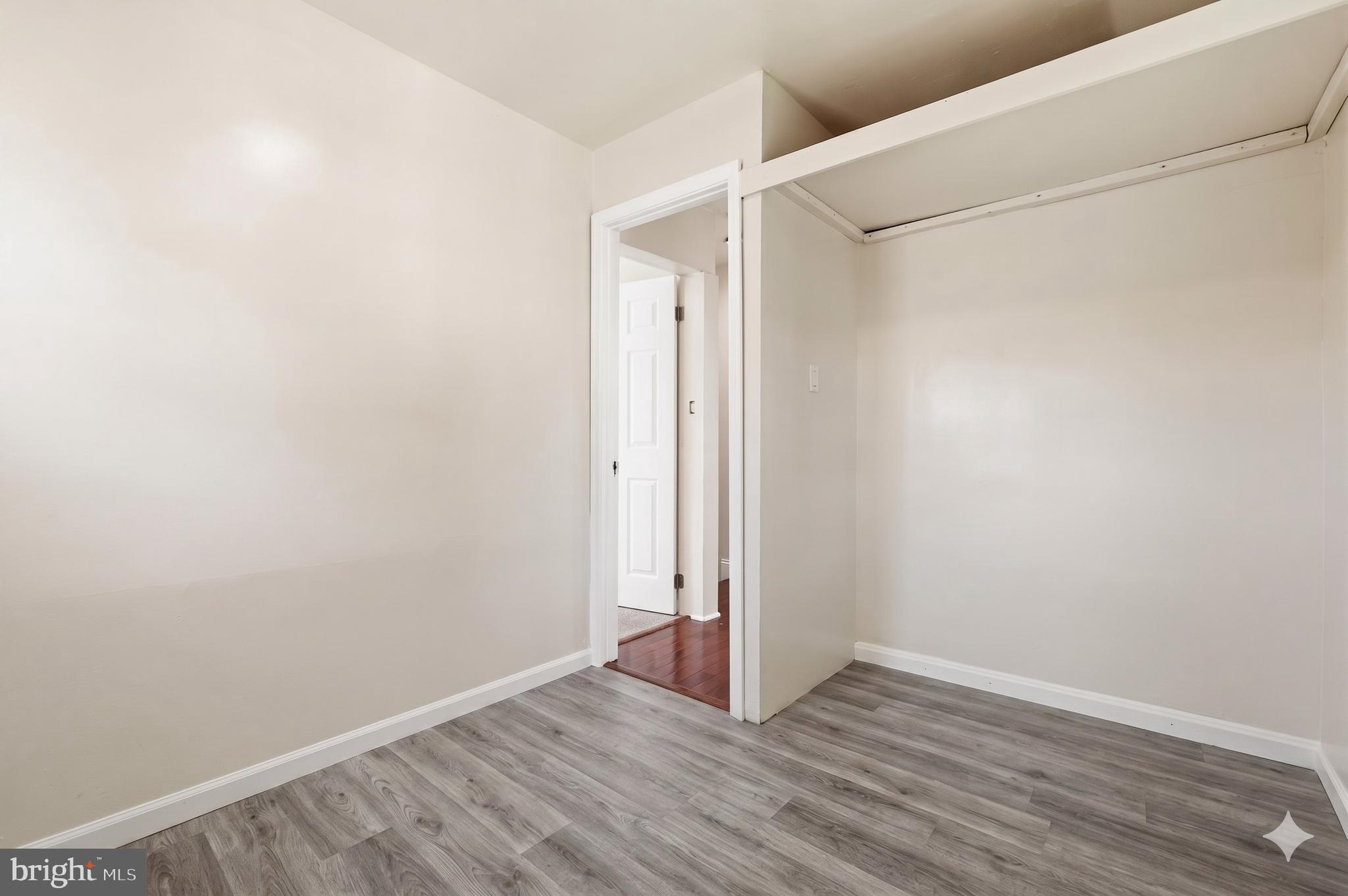 7204 East Inwood Street Landover, MD 20785 - Photo 18 of 24 a view of an empty room with wooden floor and a window