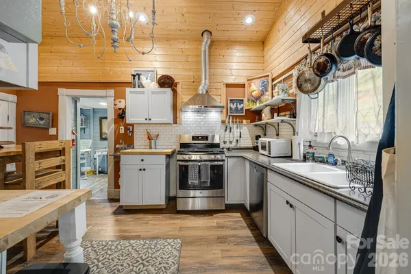 a kitchen with stainless steel appliances granite countertop a sink and cabinets