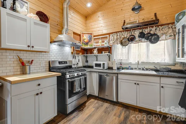 a kitchen with stainless steel appliances granite countertop a sink and cabinets