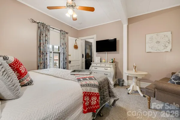 a bedroom with a bed and a flat screen tv