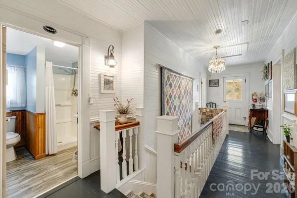 a view of a hallway view with wooden floor and staircase
