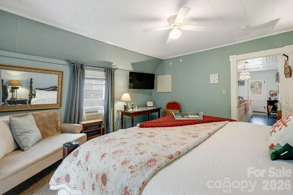 a bedroom with a bed and a couch
