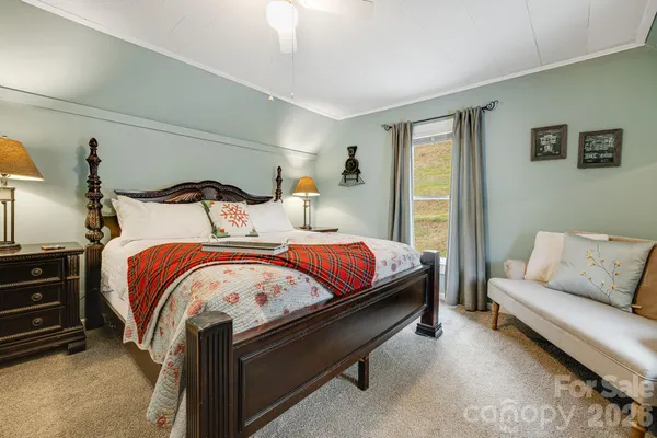 a bedroom with bed and a couch