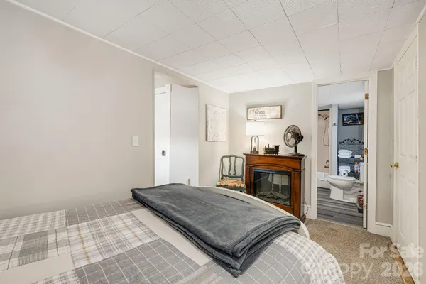 a bedroom with a bed and a fireplace