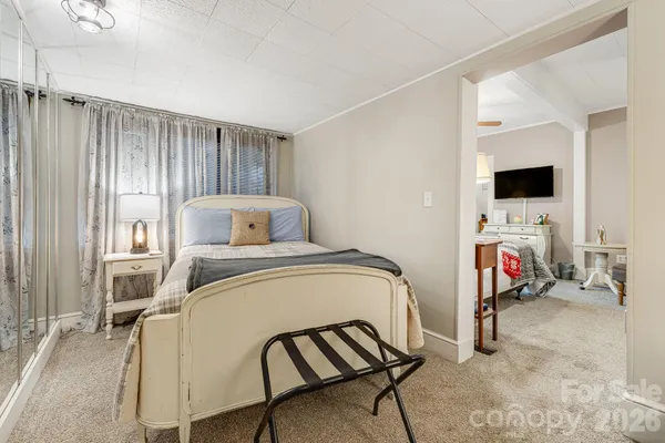 a bedroom with a bed and a tv