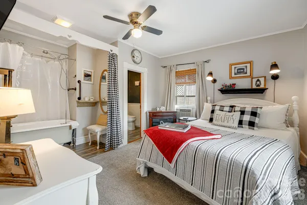 a bedroom with a bed and a chandelier