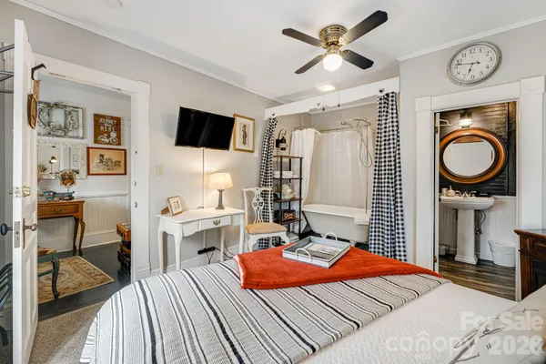 a bedroom with a bed and a chandelier