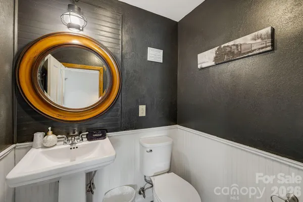 a bathroom with a toilet a sink and a mirror