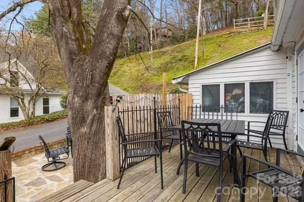 a view of balcony with furniture and wooden fence