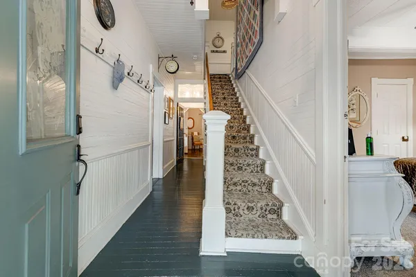 a view of entryway with furniture and wooden floor