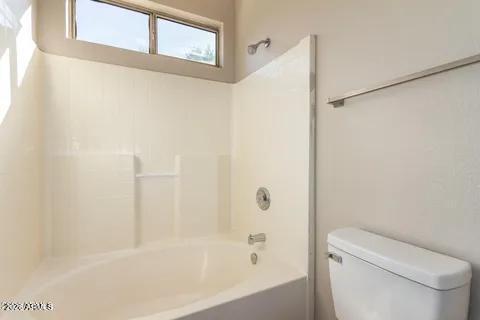 40620 North Key Lane Anthem, AZ 85086 - Photo 13 of 24 a bathroom with a bathtub and a toilet