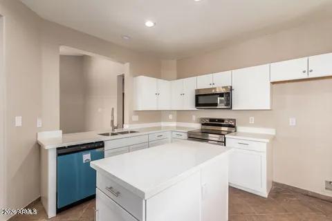 40620 North Key Lane Anthem, AZ 85086 - Photo 2 of 24 a kitchen with stainless steel appliances a stove microwave and sink