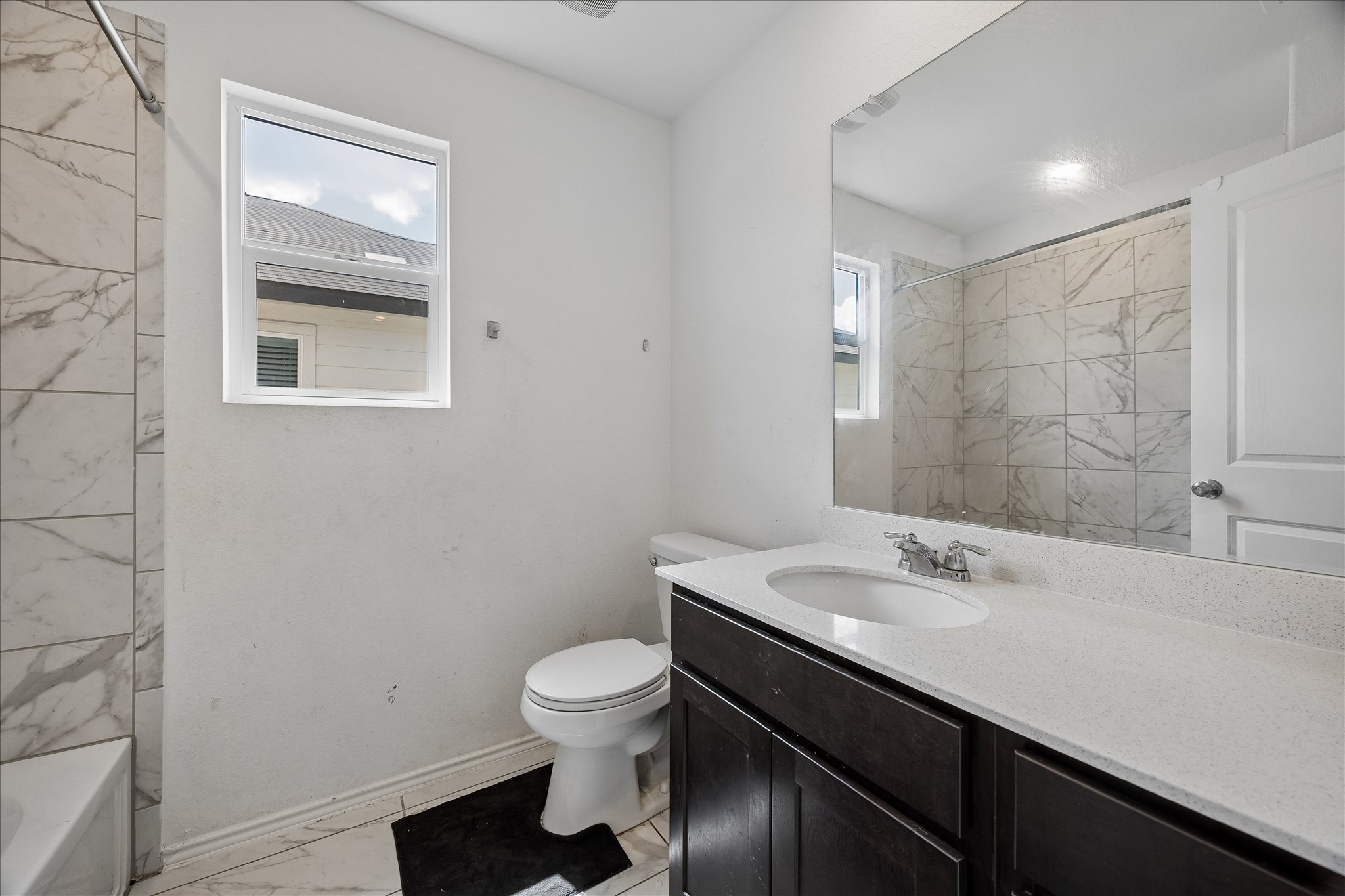 217 Canley Loop Hutto, TX 78634 - Photo 29 of 36 A well-appointed bathroom features a single vanity and a shower with tasteful tile work.