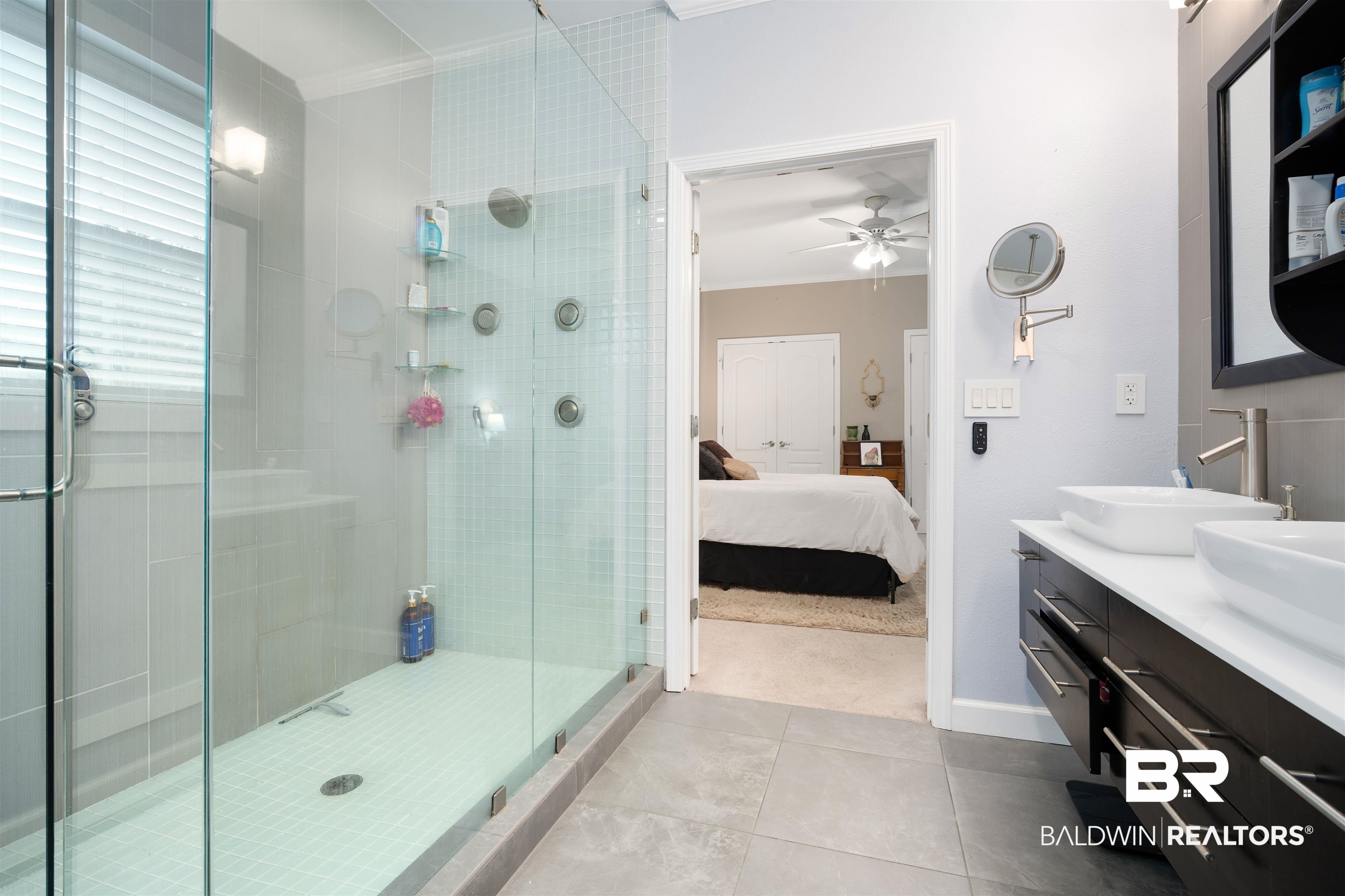25806 Pollard Road, Unit 205 Daphne, AL 36526 - Photo 14 of 26 Bathroom with a shower stall, ornamental molding, double vanity, ensuite bath, and tile patterned floors