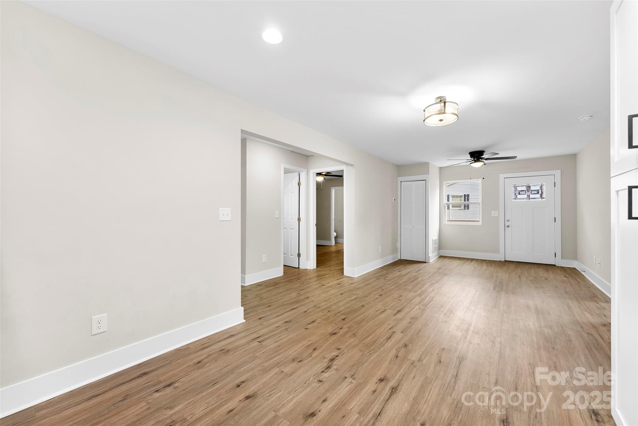601 Rhyne Circle, Unit B Gastonia, NC 28054 - Photo 11 of 32 an empty room with wooden floor and windows
