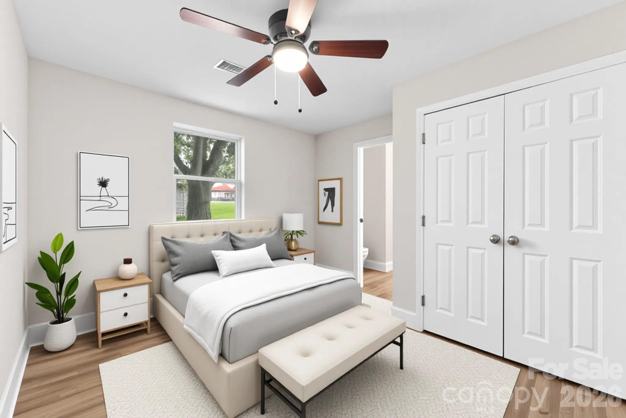 601 Rhyne Circle, Unit B Gastonia, NC 28054 - Photo 12 of 32 a bedroom with a large bed and a chandelier